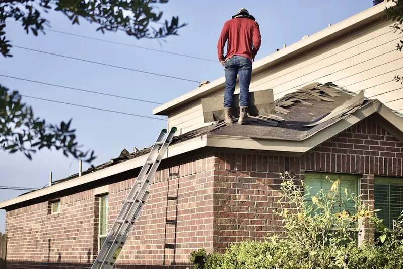 Professional roofer working on a residential roof in East Columbia